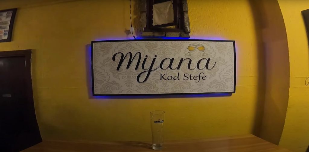 Framed and wall-mounted logo of café Mijana kod Stefe displayed inside the venue.