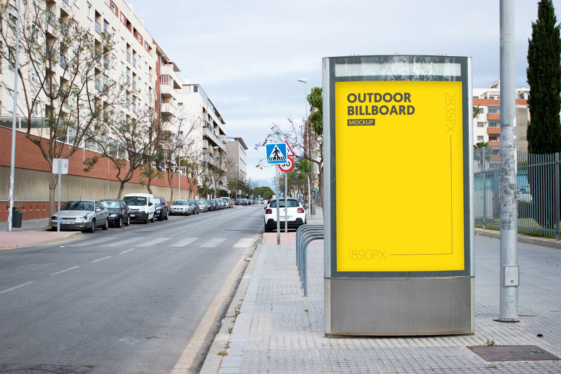 City street with a glowing billboard on the right, displaying a yellow background, representing advertising services.